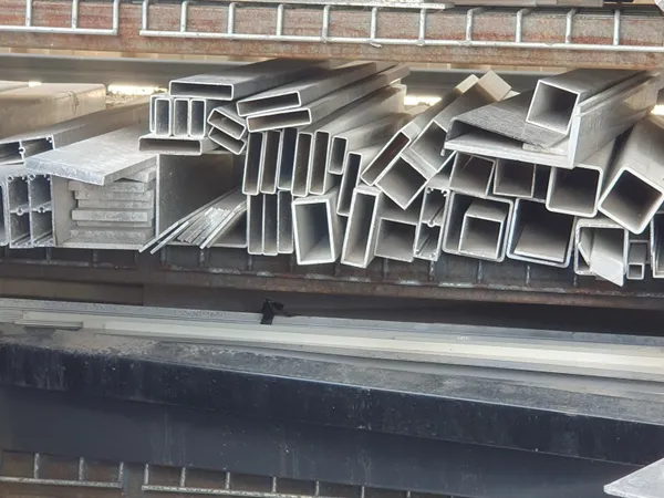 Aluminium box section and extrusion offcuts stacked on a rack
